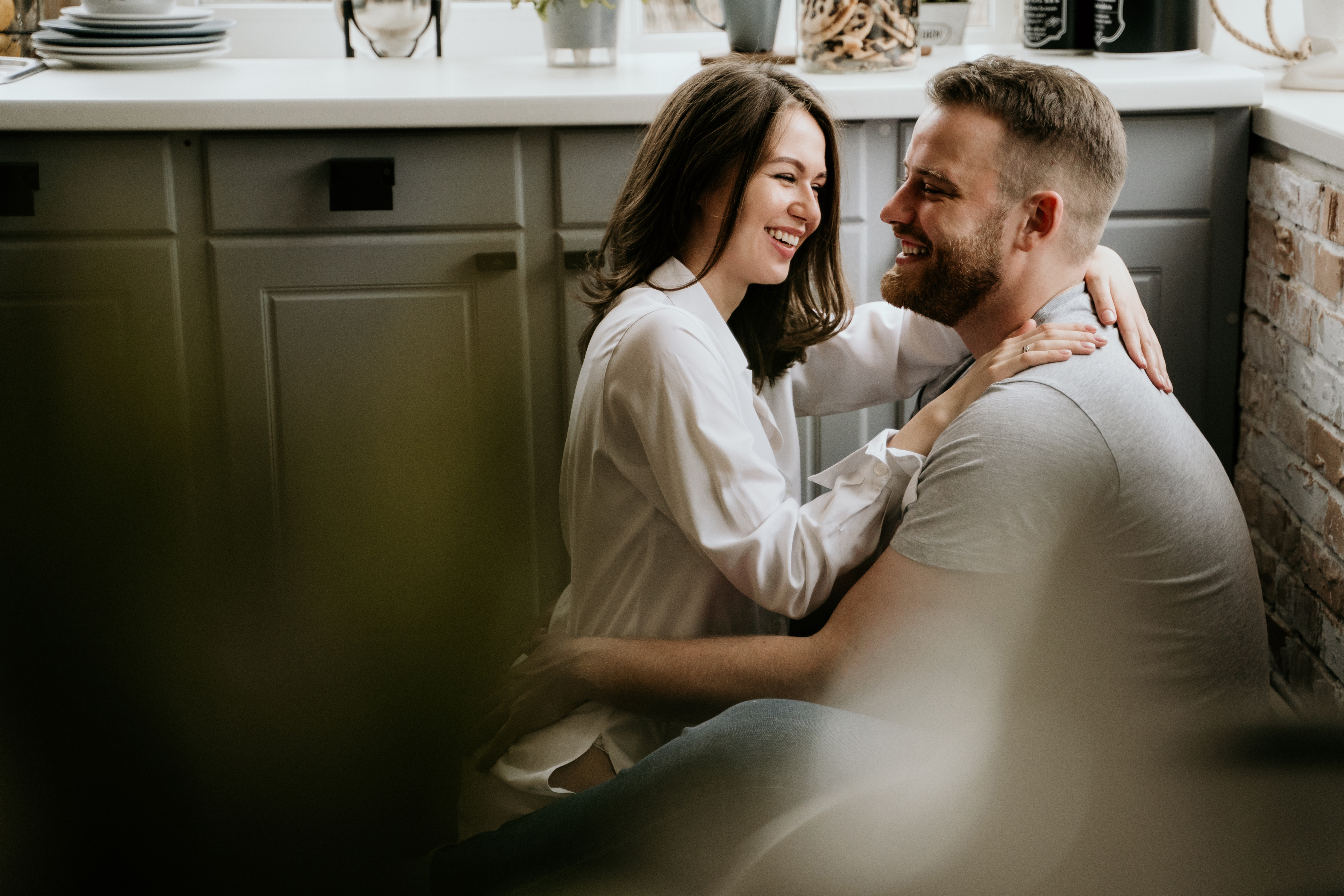girl-white-shirt-guy-gray-t-shirt-kitchen-kiss-hug.jpg